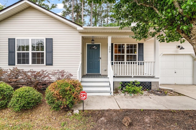 ranch-style home with a porch, driveway, and an attached garage