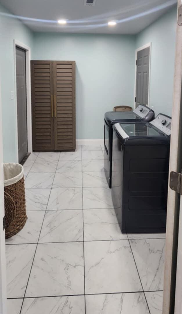 clothes washing area featuring washing machine and dryer