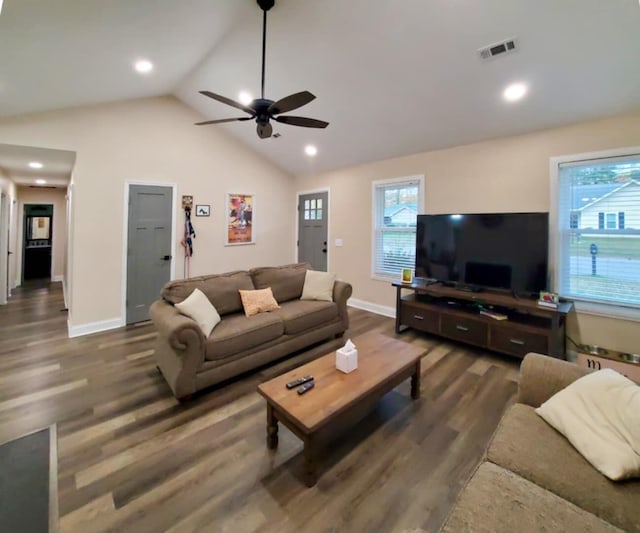 living room with plenty of natural light, dark hardwood / wood-style flooring, and vaulted ceiling