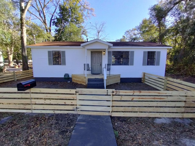 single story home with a fenced front yard and crawl space