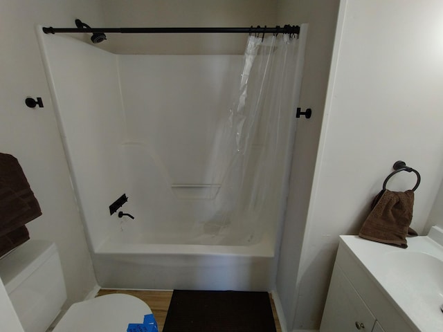 bathroom featuring toilet, shower / tub combo, and vanity