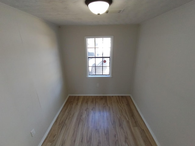 unfurnished room featuring wood finished floors and baseboards