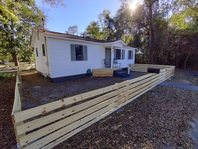 view of front facade featuring fence