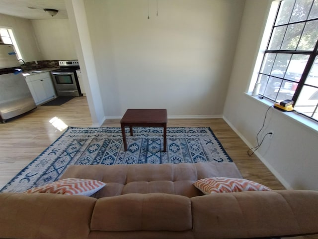 dining space with light wood-style floors and baseboards