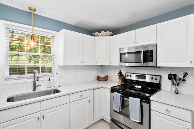 520 Yale Dr, Charleston, SC 29412 - kitchen with appliances with stainless steel finishes, a sink, backsplash, and white cabinetry
