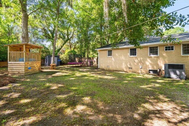 520 Yale Dr, Charleston, SC 29412 - view of yard featuring a storage unit, an outbuilding, central AC, and a trampoline