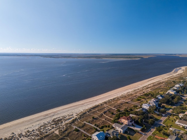 drone / aerial view featuring a water view and a beach view