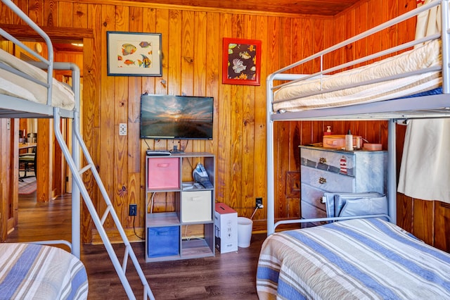 bedroom featuring dark hardwood / wood-style floors and wood walls