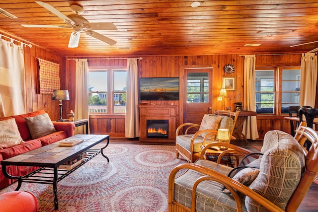 living room featuring plenty of natural light and wooden walls