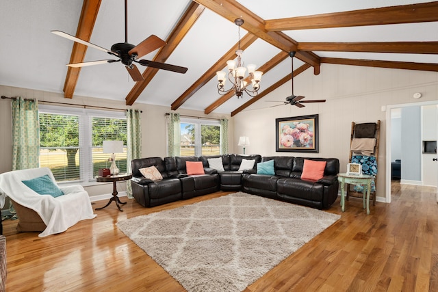 living room with vaulted ceiling with beams, light hardwood / wood-style flooring, and ceiling fan with notable chandelier