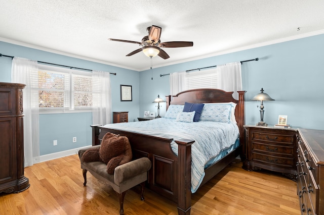 bedroom featuring ornamental molding, a textured ceiling, light hardwood / wood-style floors, and ceiling fan