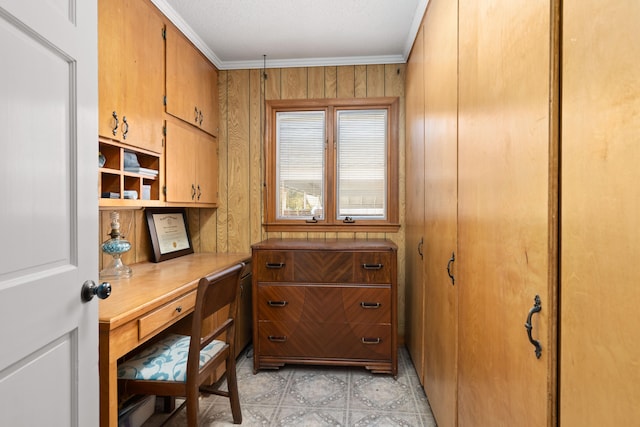 office featuring crown molding and wood walls