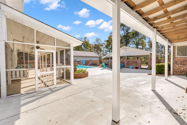 view of patio / terrace with a sunroom and ceiling fan