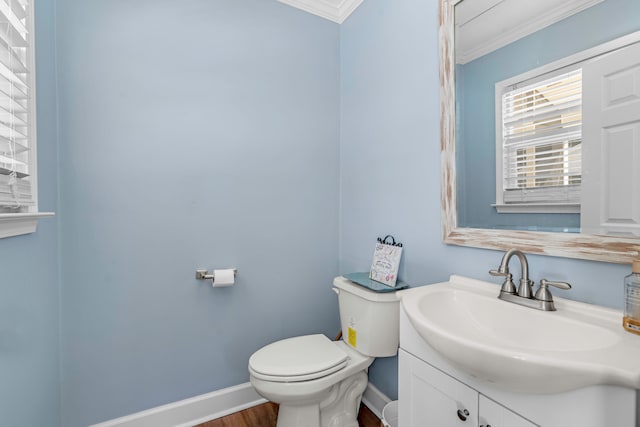 bathroom featuring vanity, crown molding, wood-type flooring, and toilet