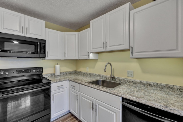 kitchen with black dishwasher, range with electric cooktop, and white cabinets