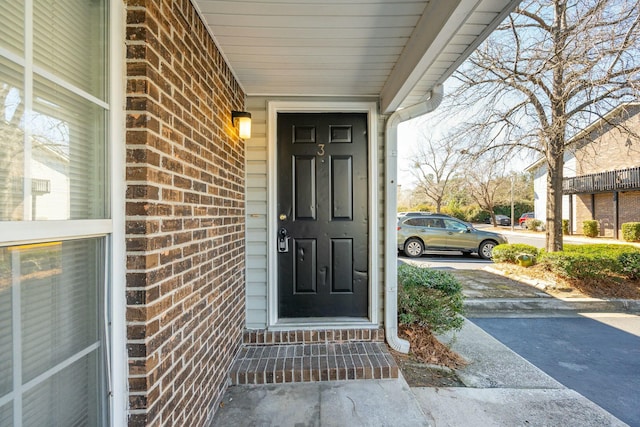 property entrance with brick siding