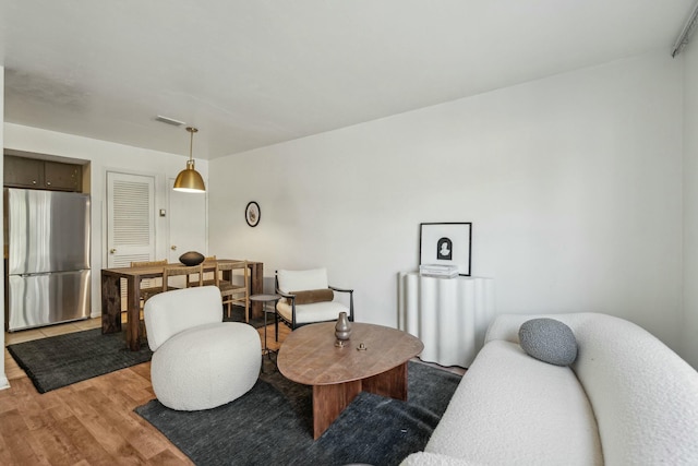 living area featuring visible vents and light wood-style flooring