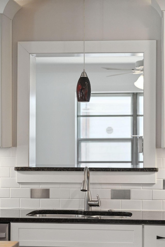 details with backsplash, white cabinetry, ceiling fan, and a sink