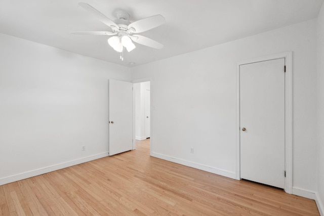 unfurnished room featuring a ceiling fan, baseboards, and light wood finished floors