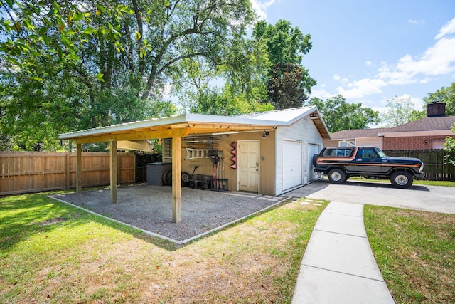 view of outbuilding featuring an outdoor structure, fence, and driveway