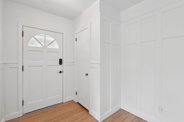 entryway with a decorative wall and light wood-type flooring