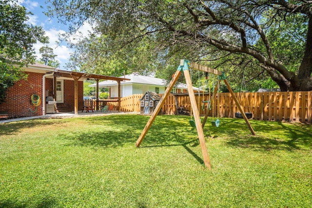view of playground with a fenced backyard, a patio, and a yard