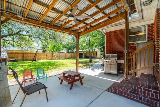 view of patio / terrace featuring a fenced backyard, ceiling fan, a playground, and grilling area