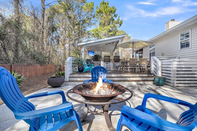 view of patio / terrace featuring a deck and an outdoor fire pit