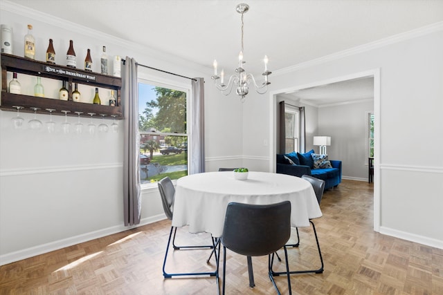 dining space featuring crown molding, baseboards, and a chandelier