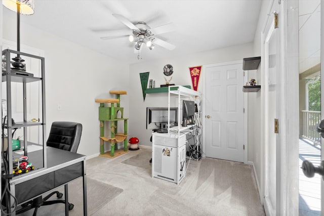 office area featuring baseboards, ceiling fan, and light colored carpet