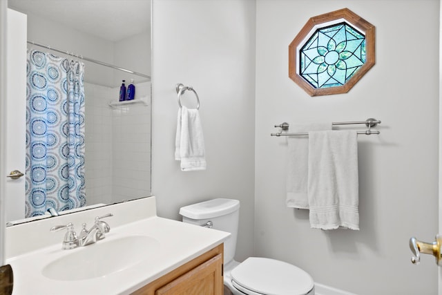 bathroom featuring vanity, a shower with curtain, and toilet