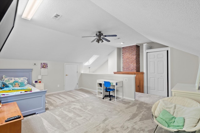 bedroom with carpet floors, a textured ceiling, visible vents, and lofted ceiling with skylight