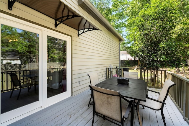 wooden deck with fence and outdoor dining area