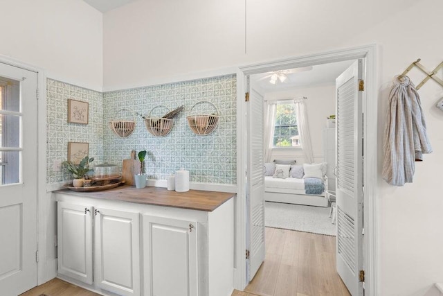 interior space featuring light hardwood / wood-style flooring and white cabinets