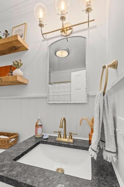 bathroom featuring ornamental molding, vanity, and a shower with shower curtain