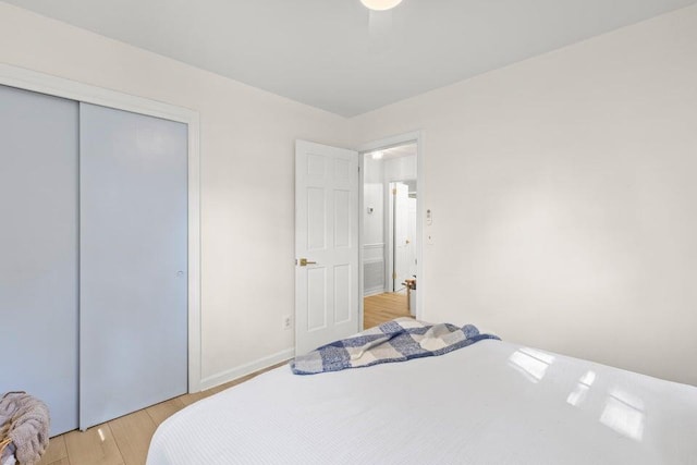 bedroom featuring light hardwood / wood-style floors and a closet