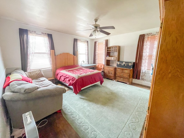 bedroom featuring multiple windows and ceiling fan