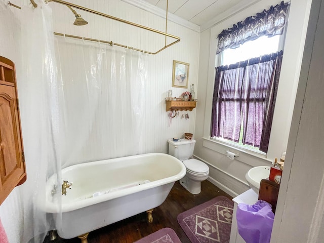 bathroom with crown molding, wood-type flooring, shower / tub combo, and toilet