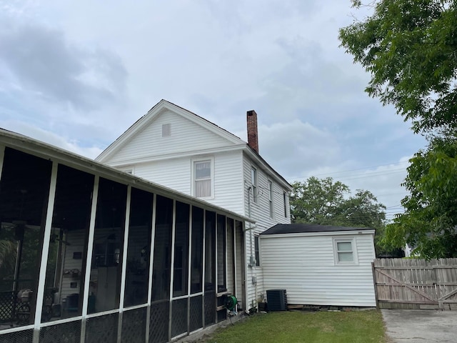 rear view of property featuring a sunroom