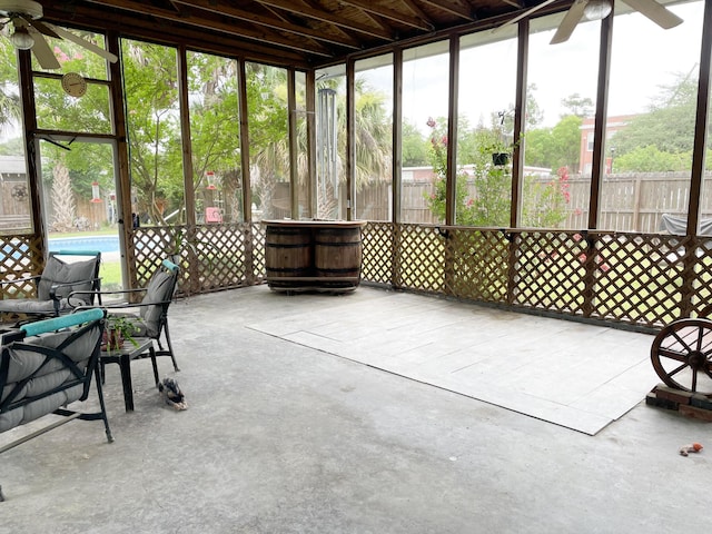 unfurnished sunroom with ceiling fan