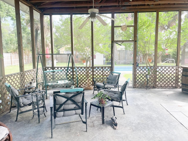 sunroom with ceiling fan and a healthy amount of sunlight