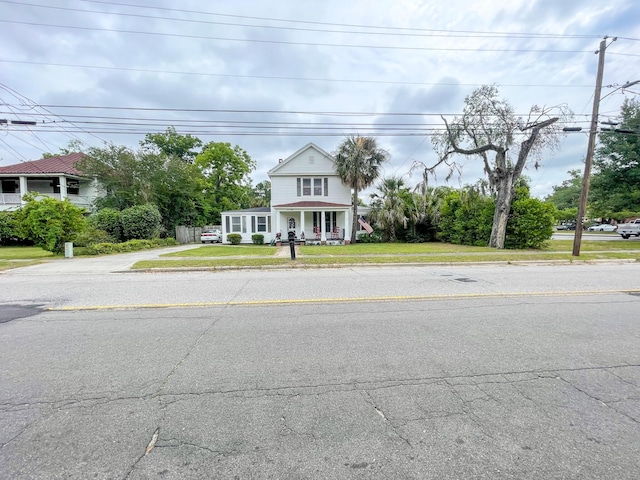 view of front facade with covered porch and a front yard