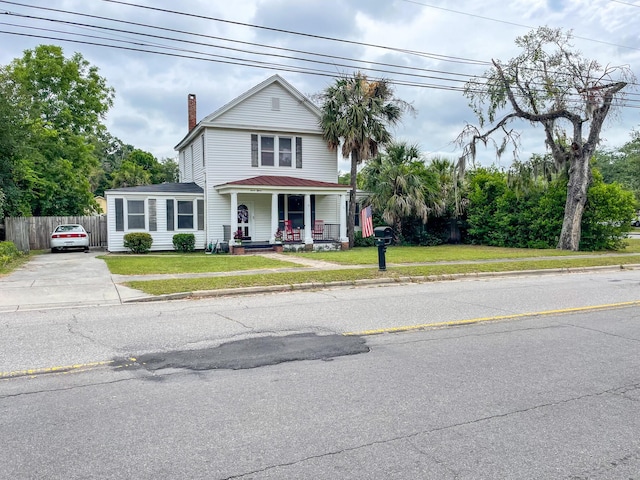 view of front of property featuring a porch and a front lawn