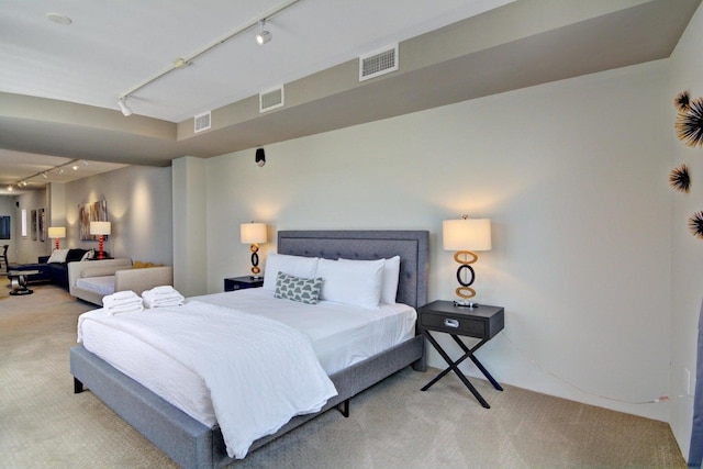 bedroom featuring visible vents, rail lighting, and carpet floors