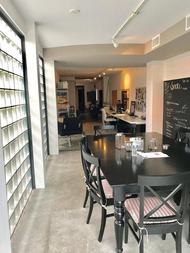 dining space with visible vents and concrete floors