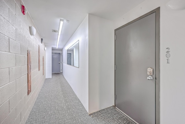 hall with visible vents and concrete block wall