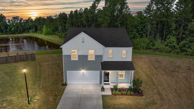 view of front of property with a yard and a garage