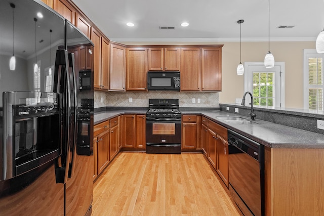 3588 Bagley Dr, Mount Pleasant, SC 29466 - kitchen with black appliances, a sink, brown cabinets, crown molding, and recessed lighting