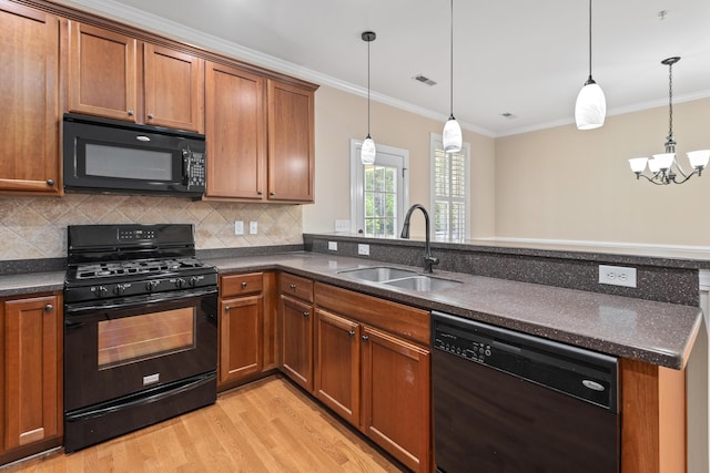 3588 Bagley Dr, Mount Pleasant, SC 29466 - kitchen featuring black appliances, a sink, light wood-style flooring, ornamental molding, and brown cabinets