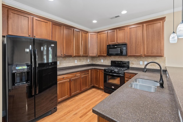 3588 Bagley Dr, Mount Pleasant, SC 29466 - kitchen featuring black appliances, a sink, brown cabinetry, ornamental molding, and decorative light fixtures